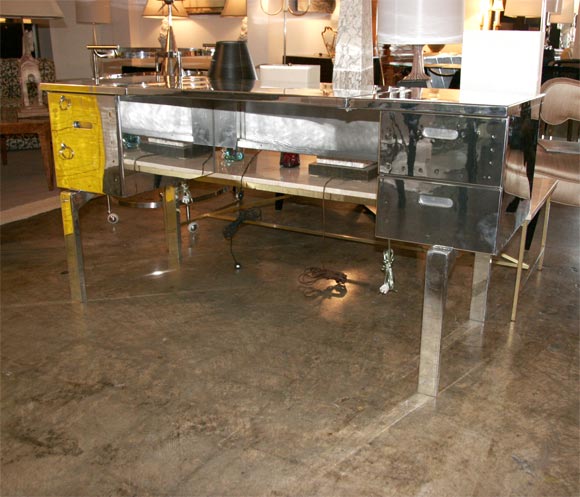 An amazing polished aluminum campaign desk with drawers.  Used by the U.S. military during World War II, this desk folds up into the size of a large suitcase.  One of sixteen available.