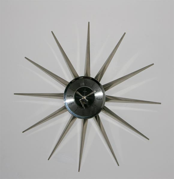 Welby starburst clock with key wind-up and balck and chrome face.