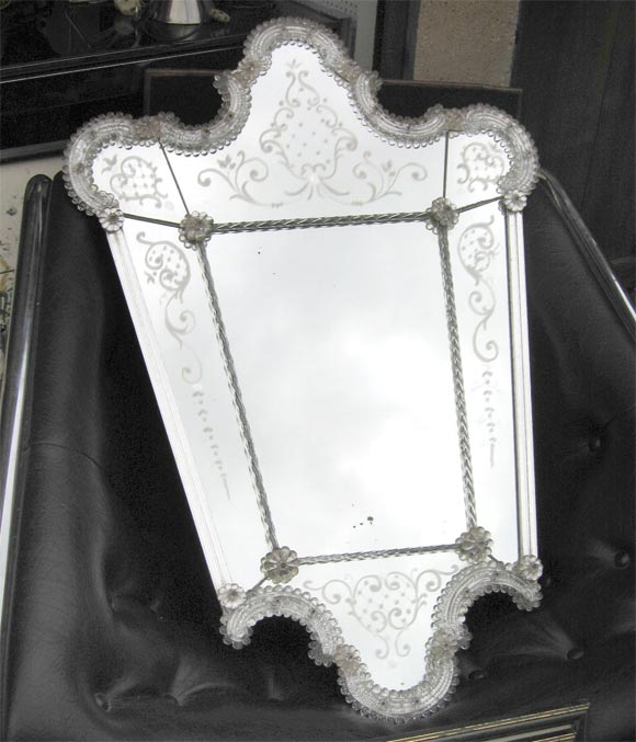 Italian  mirror with curved top and bottom. Decoration of engraved flowers and applied glass flowers.