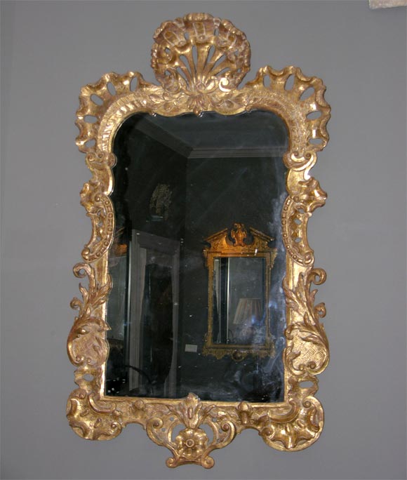 18th c. Irish carved and giltwood looking glass having a pierced carved shell cartouche, rocaille and scroll carved crest over foliate and basketwork sides and bottom, the gilding largely original, the glass is 18th Century, but not original to this