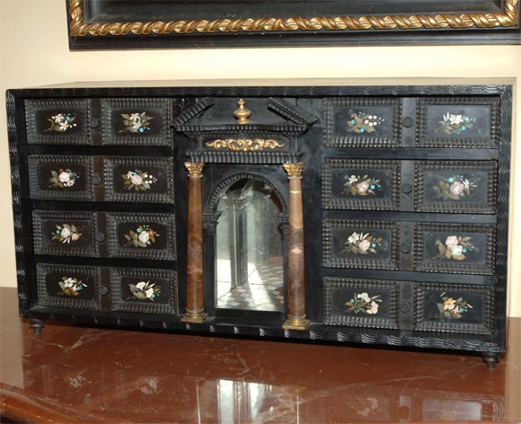 Unique Florentine ebonized pietra dura collector's cabinet, inlaid with flowers, with two marble columns.