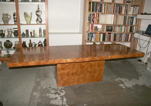 A beautiful pedestal table by Milo Baughman.  The luxurious burl olive veneer would not look out of place on the fold-down picnic tables in a Park Ward Rolls-Royce. The two leaves (each one is 18