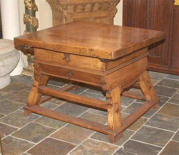Alpine baroque walnut rent table, the rectangular top with lobed corners above a plain frieze, with a secret slide drawer, raised on angled, shaped trestled supports, joined by boxed stretchers.