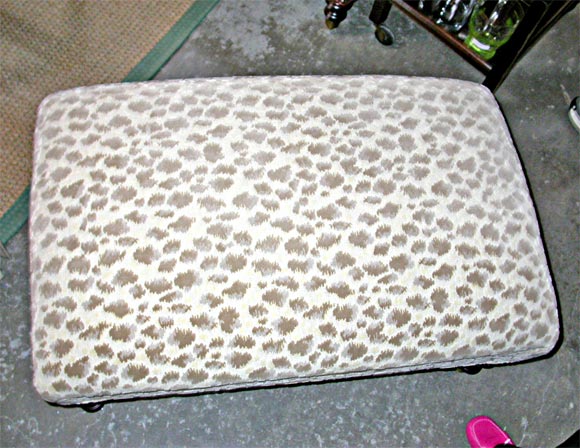 Animal Print Upholstered Ottoman, Brunschwig & Fils Fabric, with turned wood legs and brass casters.