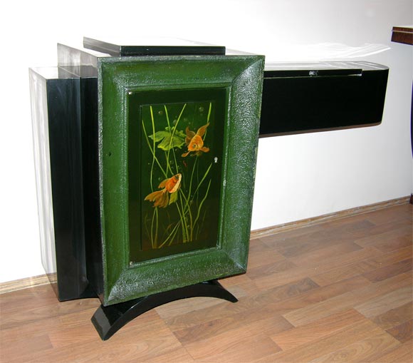 An unusual asymmetrical cabinet designed by René Drouet and decorated by Gaston Suisse from circa 1930s, at the time being used as a foyer piece. In black lacquer wood, door surrounded by a dark green frame and masterfully decorated with a gold-fish