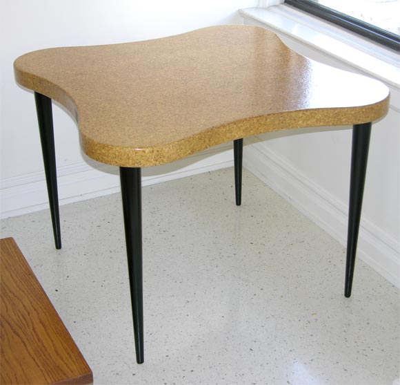 A rich, cork-topped game table by Paul Frankl for the Johnson Furniture Company, over tapering ebonized legs.  Awfully chic.