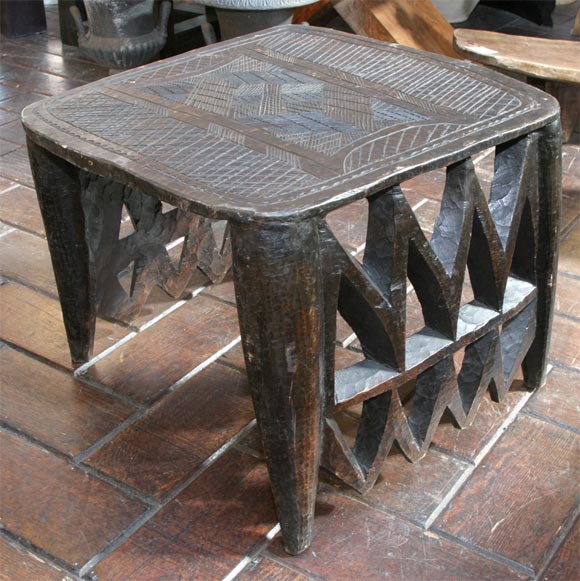 The Nupe tribe numbering about 1.2 million are an important Moslem tribe living mainly on the north bank of the Niger.Their art is non-figurative and decorative. This exquisite stool was used as prestige objects on market days and important meetings.