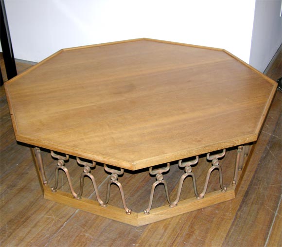 Large low octagonal table in bleach walnut with cast metal lattice-work base.