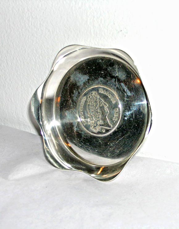 Sterling ashtray with a coin set in the center