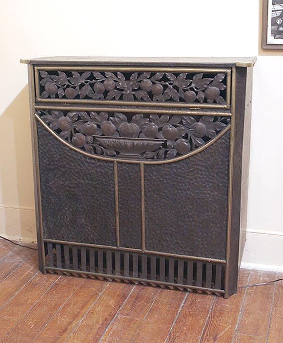 Highly decorative French iron and brass Radiator cover.  Features cut out & hammered tin in fruit and leaves design.  Brass trim.