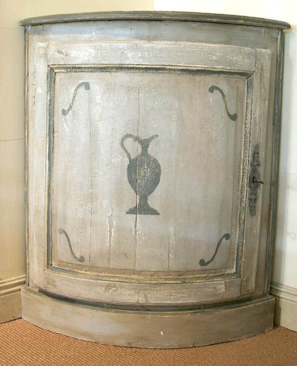 CUPBOARDS ARE PAINTED WITH URN MOTIFS GRAY ON GRAY