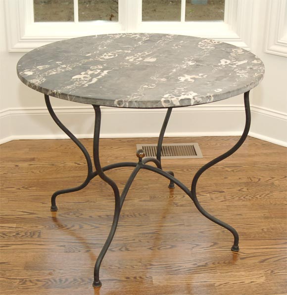 Marble table with an iron base with brass ball