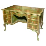 Green chinoisery desk with raised lacquer details.