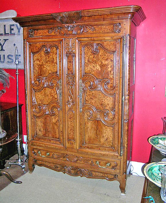 An exceptional quality armoire with superior color and carving.  From the Bresse region of France with design and construction motifs and characteristics unique to this region. The body is constructed in cherry, while the panels are highly figured