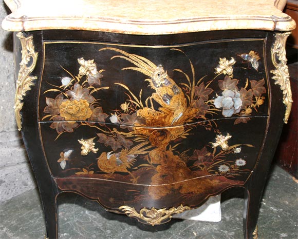 Small black lacquered Chinoiserie two-drawer commode with gold and silver paint, inlaid mother of pearl and abalone, bronze hardware (possibly not of the period), and original marble top.