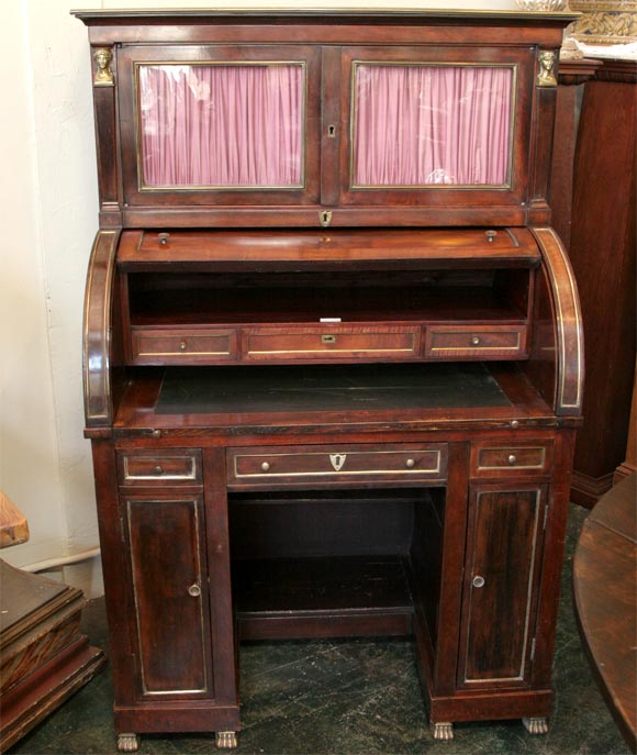 French mahogany cylinder roll top secretary with leather inset writing surface and brass trim and bronze mounts.  The leather inset writing surface is not original and should be replaced.