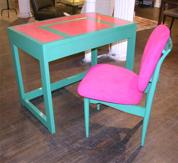 Vibrant & beautifully detailed table of green lacquer & inset pink leather with greek-key embossing.   This playful desk has a single drawer & a lift-up mirror.  Accompanied by a matching lacquered chair, upholstered in pink ultrasuede. This is a