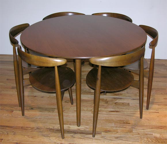 Classic Wegner compact table set illustrating his innovative design for Fritz Hansen, Denmark.  This design maximizes seating while minimizing footprint.  Matching set of six chairs are three-legged and stackable.<br />
Sold as a set.