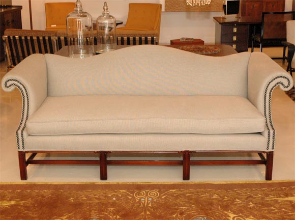 Classic camelback sofa re-upholstered in belgian linen.  Bronze tacks to the front. Carved solid mahogany base.  Seat height 20