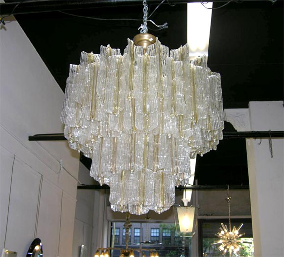 SIGNED VENINI CHANDELIER. 4 TAPERED TIERS OF GLASS, EACH RIPPLED SEGMENT OF CLEAR GLASSS WITH A GOLD CENTER.  VERY IMPRESSIVE WITH A BEAUTIFUL LIGHT.