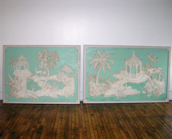 Two large decorative panels with chinoiseries carved in white on a blue green background, framed.  One is signed Allen Townsend Terrell, 1938.  One is 76.25