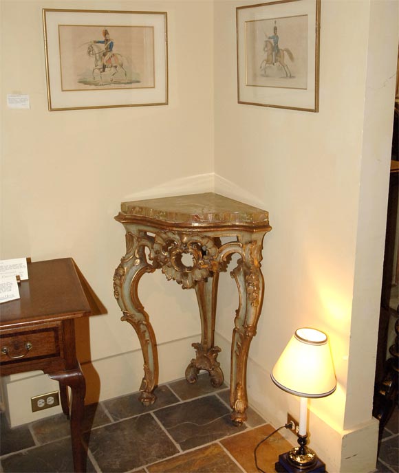 Pair of Italian parcel-gilt corner consoles with marble tops