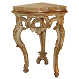 Pair of Italian parcel-gilt corner consoles with marble tops