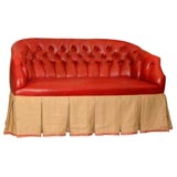 A Tufted Red Leather Settee With a Belgian Linen Skirt
