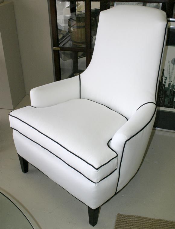 Beautiful and comfortable, these high-style armchairs in classic white w/ black piping.