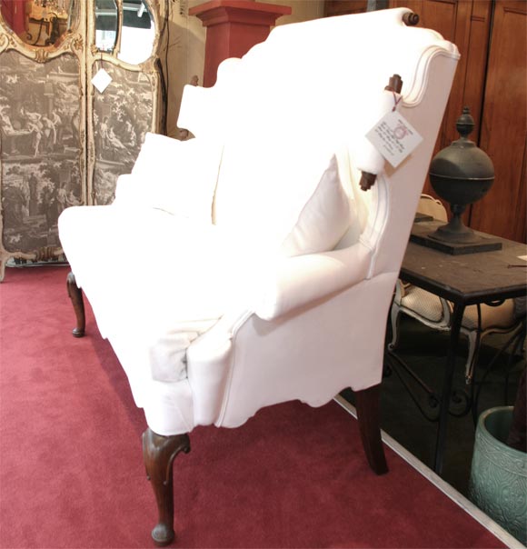 A Queen Anne style high Back Setee, with scroll back and sides, with a scalloped apron. With a down cushion.