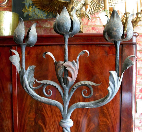 Italian hand wrought iron candelabra of floral design. Twisted rope metal stands with large, scrolling leaf adornments. 3 lights each, for candles.