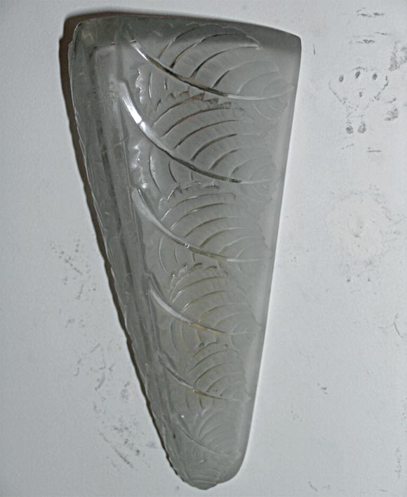 Lalique wall sconces, clear and frosted glass molded with a leaves design, electrified. Additional pairs and matching chandelier available.
