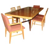 Dining table with 6 chairs by Gilbert Rohde