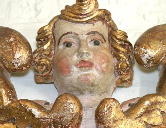 An Italian carved, painted and giltwood cherub, early 18th century
