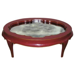 An Oval Deep Coral Lacquered Low Table.