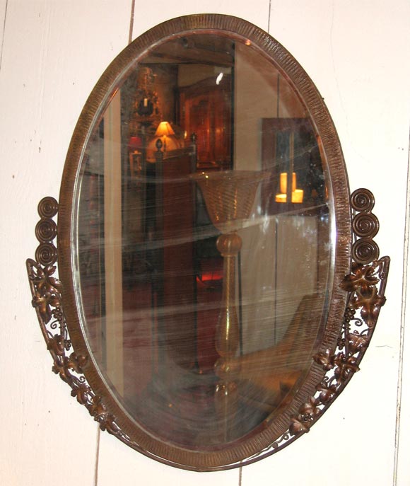 Art Déco mirror attributed to Paul Kiss, framed in wrought iron decorated with bunches of grapes.