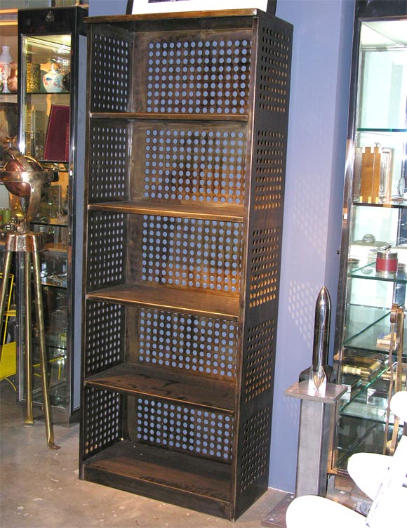 The is a perforated factory shelving unit/bookcase