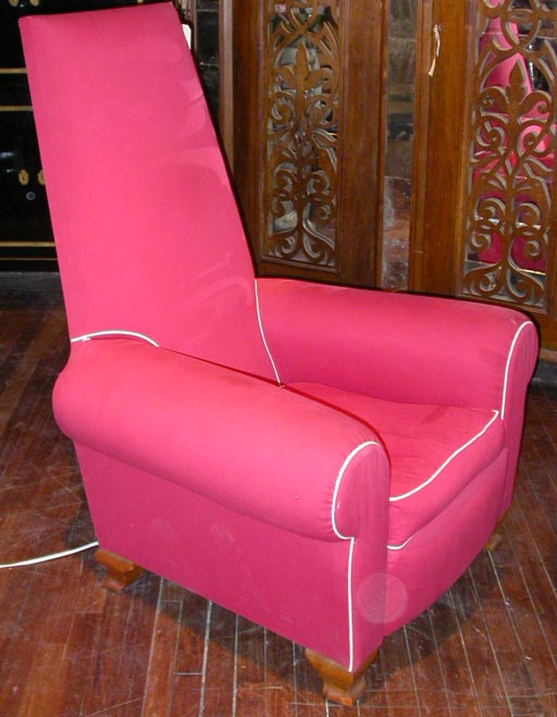 Unusual armchair with a high back and rolled arms