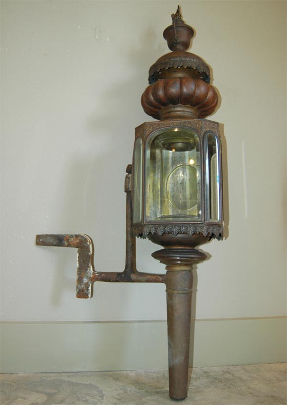 Large carriage lantern with ornate details and beveled glass.