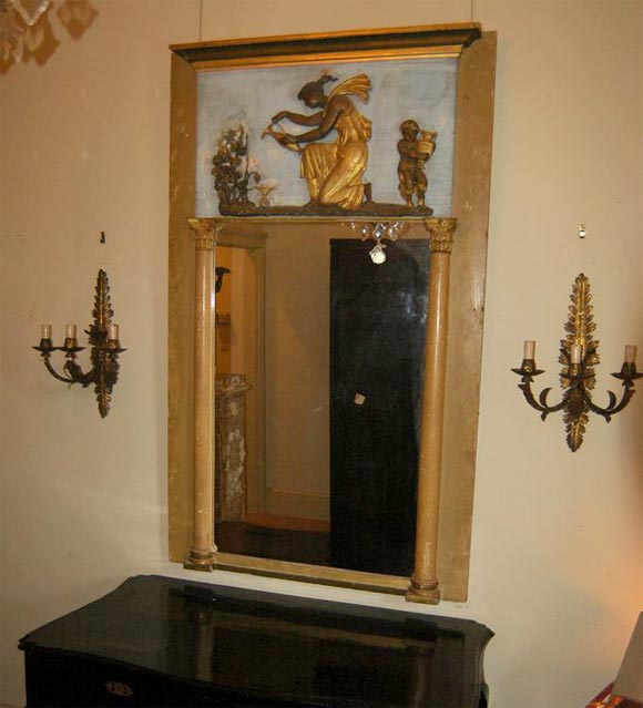 Painted trumeau with gilded bas relief figures on pale blue field. All paint appears to be original. The mirror is not original.