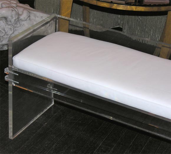 3/4 inch lucite connected by screws.White leather cushion.