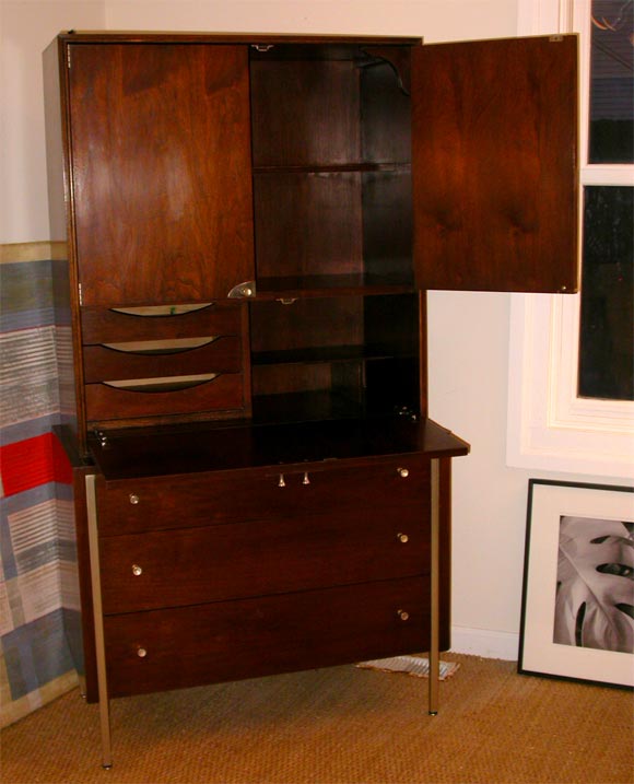 A Raymond Lowey mahogany veneer with nickel hardware drop front desk/cabinet. Great storage for books, papers and clothing.