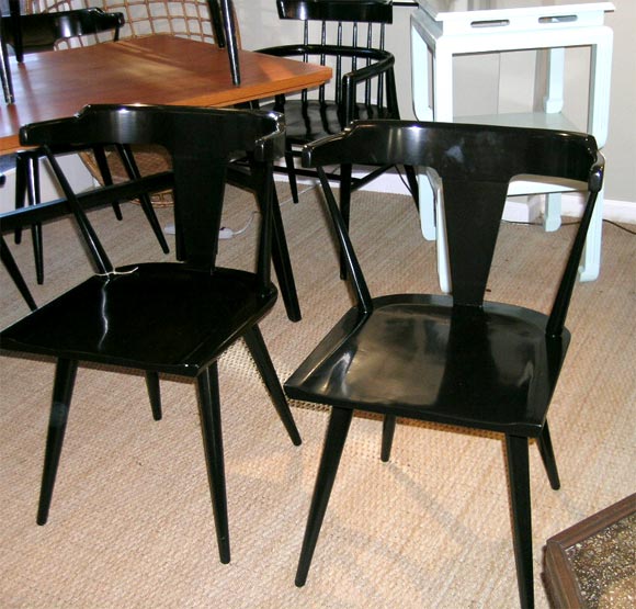 A set of four Paul Mc Cobb side chairs in black lacquer