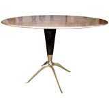A Round Marble Topped Dining Table with a Star Shaped Brass Base