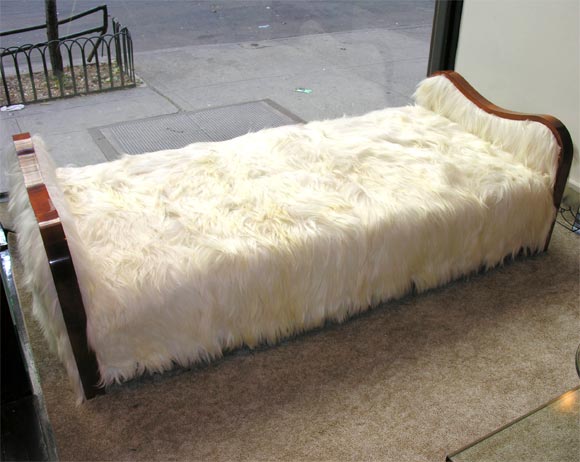 fantastic Mahogany daybed by Jean Royere. this ondulation design is uphostered in long haired Mongolian lamb.<br />
various models can be seen in the books on the artist.