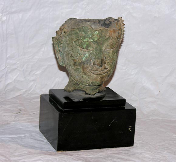 The most serene expression illuminates this bronze Buddha head in Chien Seng style coming from a century old archeological excavation. A deep green patina flourishes throughout the surface. A similar example was exhibited recently at the exhibition: