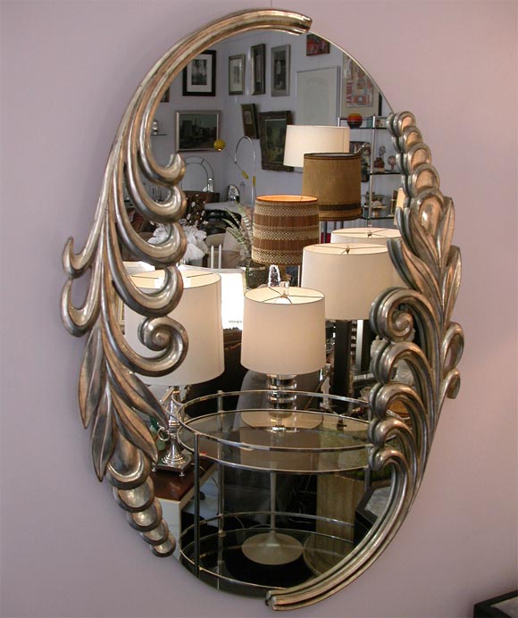 A Fanciful White Gold Framed Oval Mirror