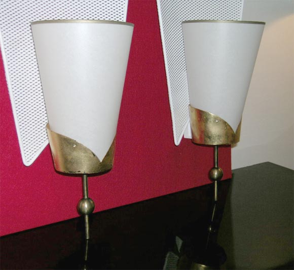 Large pair of sconces with perforated metal backings, gilt cup holding a shade.

Two pairs available.