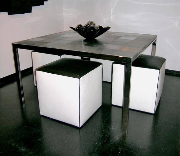 Large dining table in stainless steel and brushed aluminum. The tabletop design is a woven look, created by bands of brushed aluminum set in alternating directions. Superb quality construction.