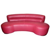 Red leather kidney shaped sofa